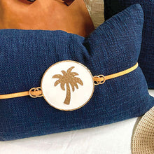 Load image into Gallery viewer, Luxe Navy palm cushion with tan suede strap to compliment your resort style home or tropical room. 35cm x 35cm
