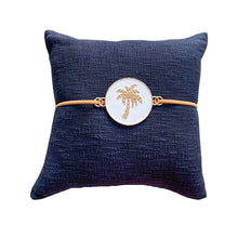Load image into Gallery viewer, Luxe Navy palm cushion with tan suede strap to compliment your resort style home or tropical room. 50cm x 50cm
