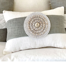 Load image into Gallery viewer, White coastal cushion with a sage colour sash, wrapped around the lumbar cushion with shell and rattan detail is a must for a coastal style. 
